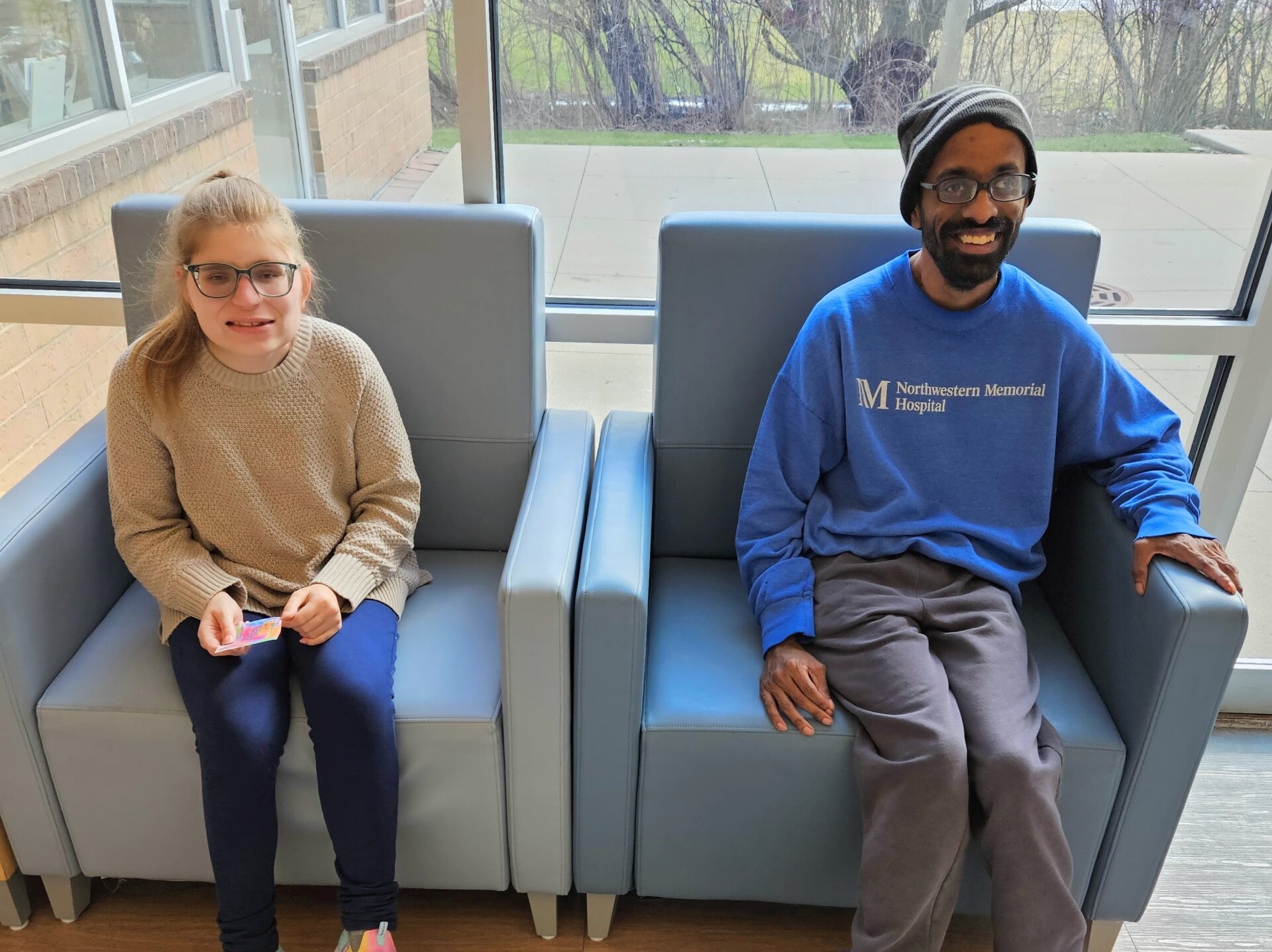 Two CEL members smiling in hallway.