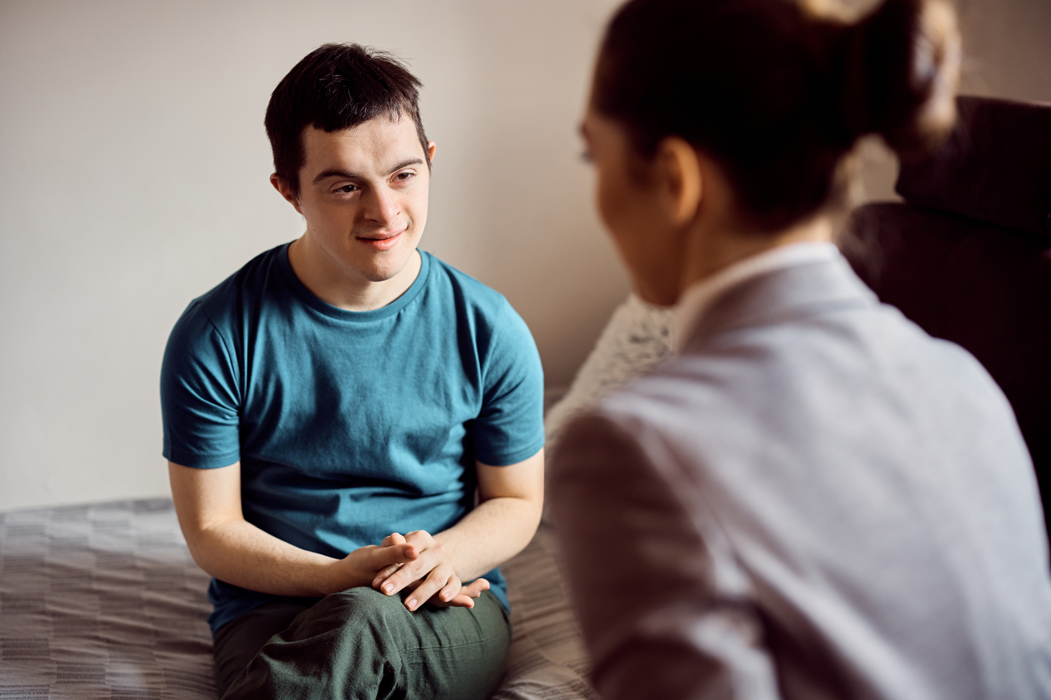 A stock photo of guy receiving therapy services from therapist.