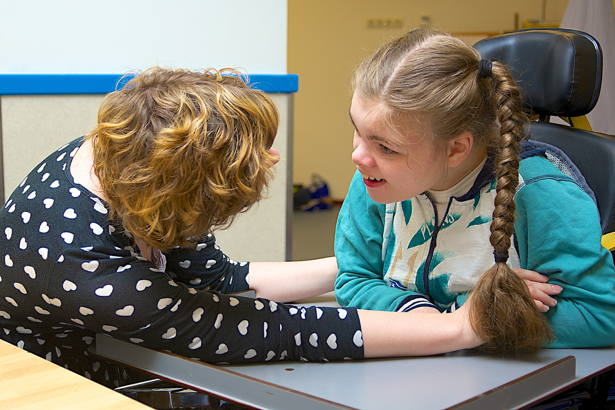 A stock photo of girl receiving therapy services from therapist.
