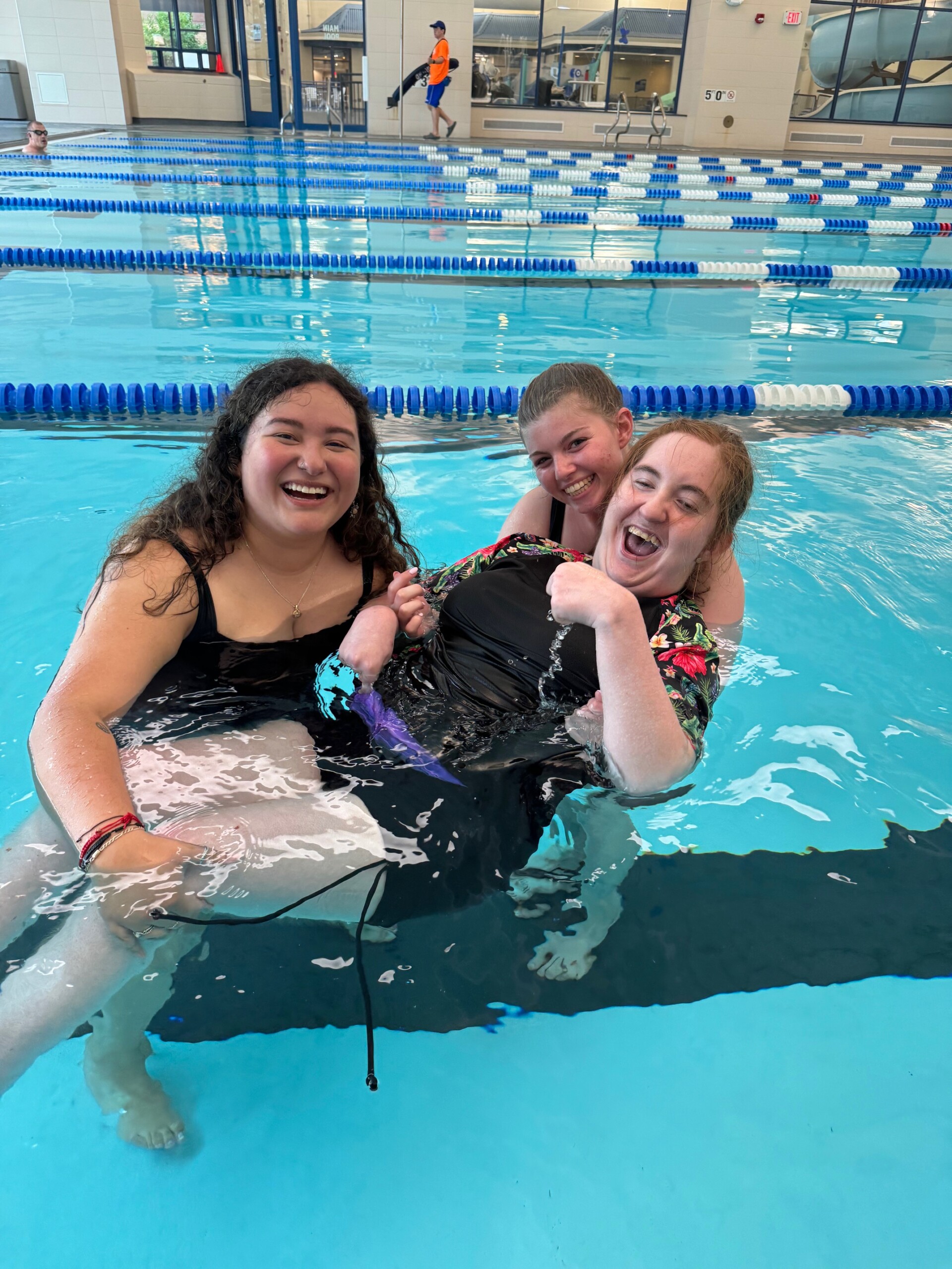 A photo of CEL member with staff swimming in pool.