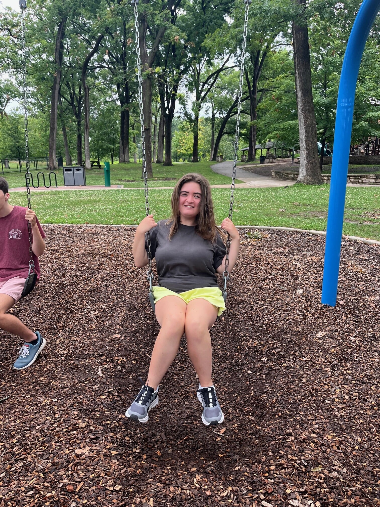 A picture of CEL member swimming and smiling on the swing.