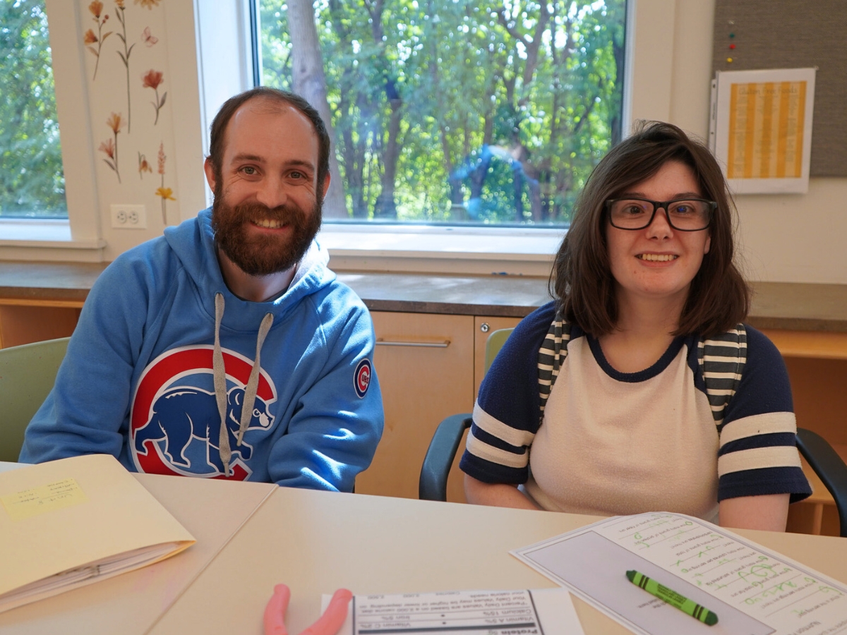 Catalyst Life Skills Program Member Working with staff Ryan on activity.