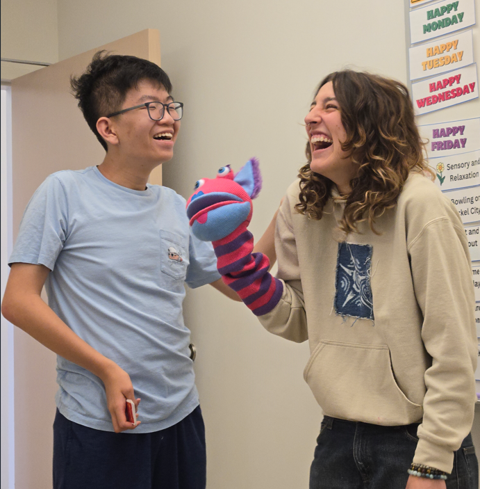 A photo of CEL member with staff during emotional regulation activity.