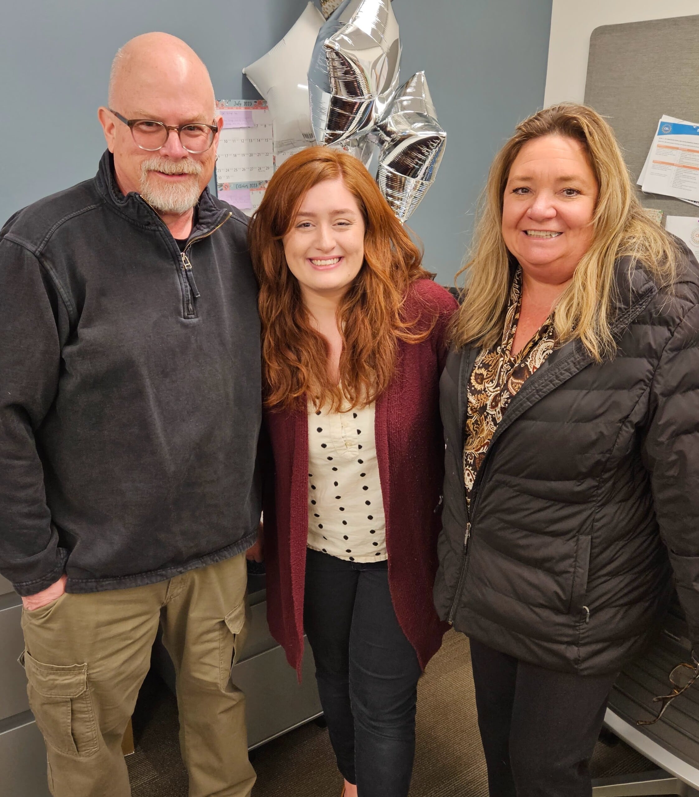 Employment team smiling in the CEL office. Pictured are manager Samantha and two employment specialists, Don and Tina.