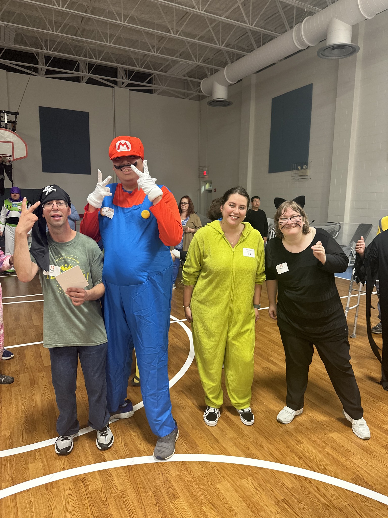 A group of CEL members with volunteer posing iin Halloween Costume for Harvest Dance.