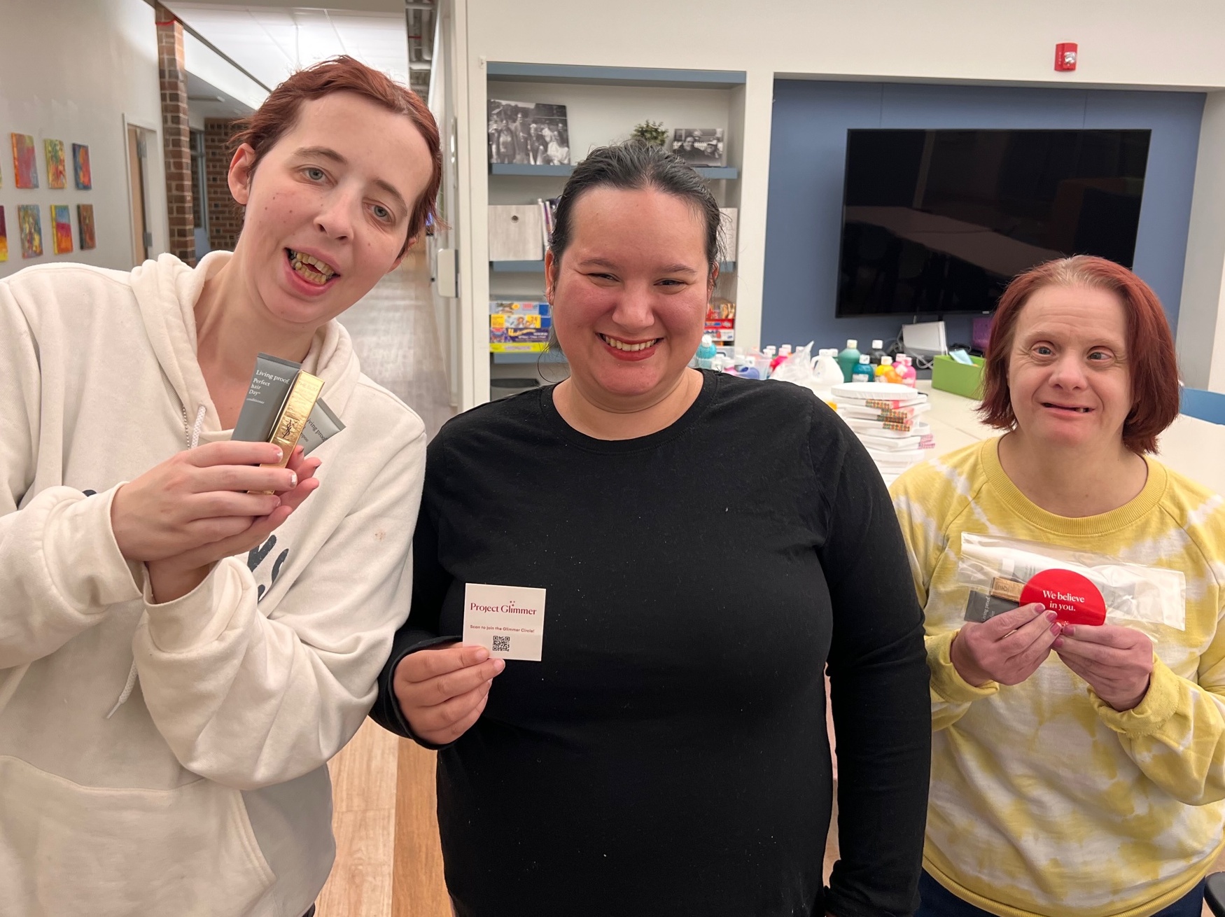 CEL Ladies Night participants posing with gifted products from the Project Glimmer organization.