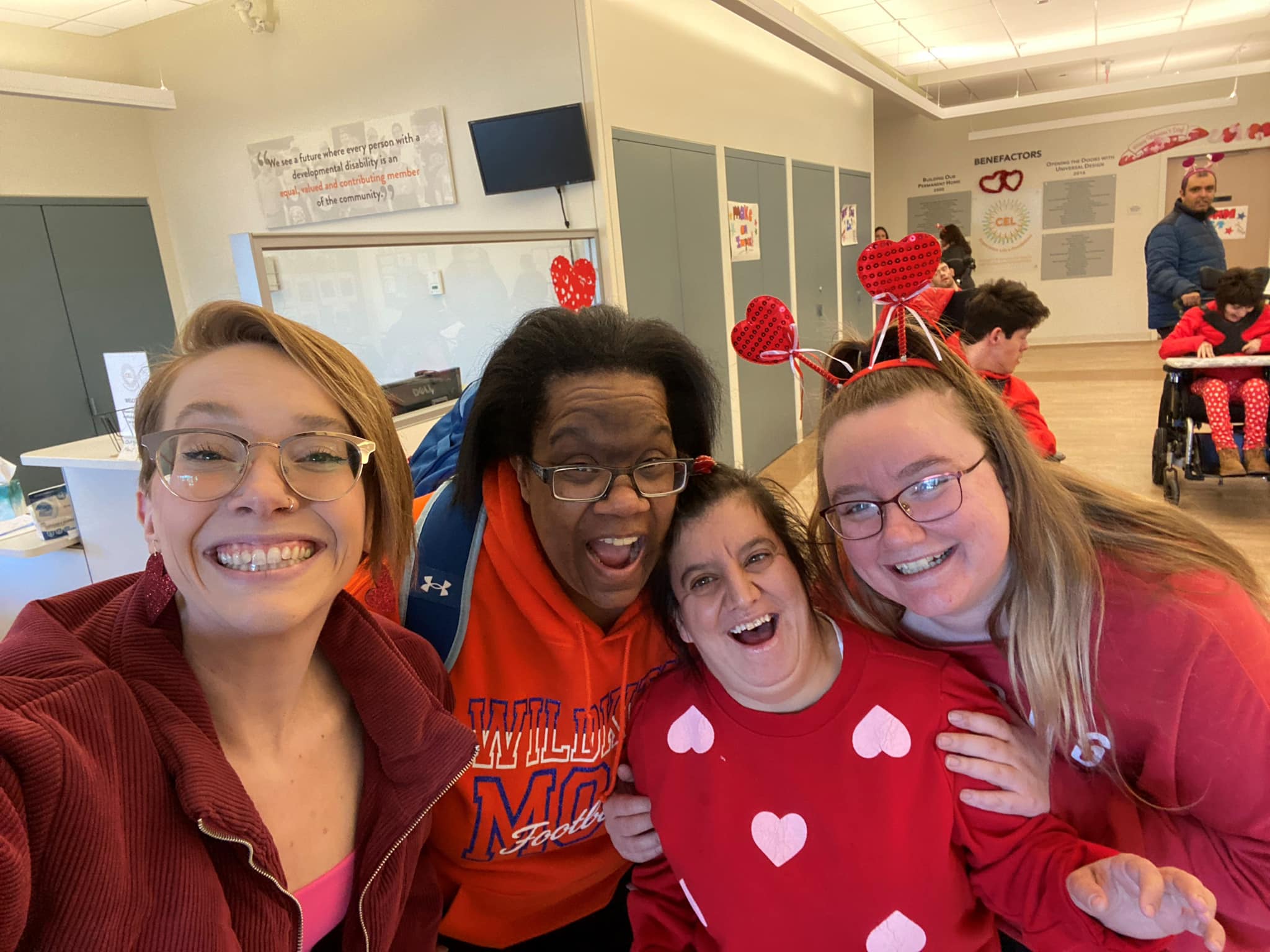 A picture of CEL members with staff smiling wearing all red.