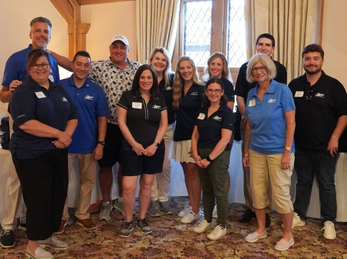 A group picture of AIT Title Golf Sponsors volunteers smiling.