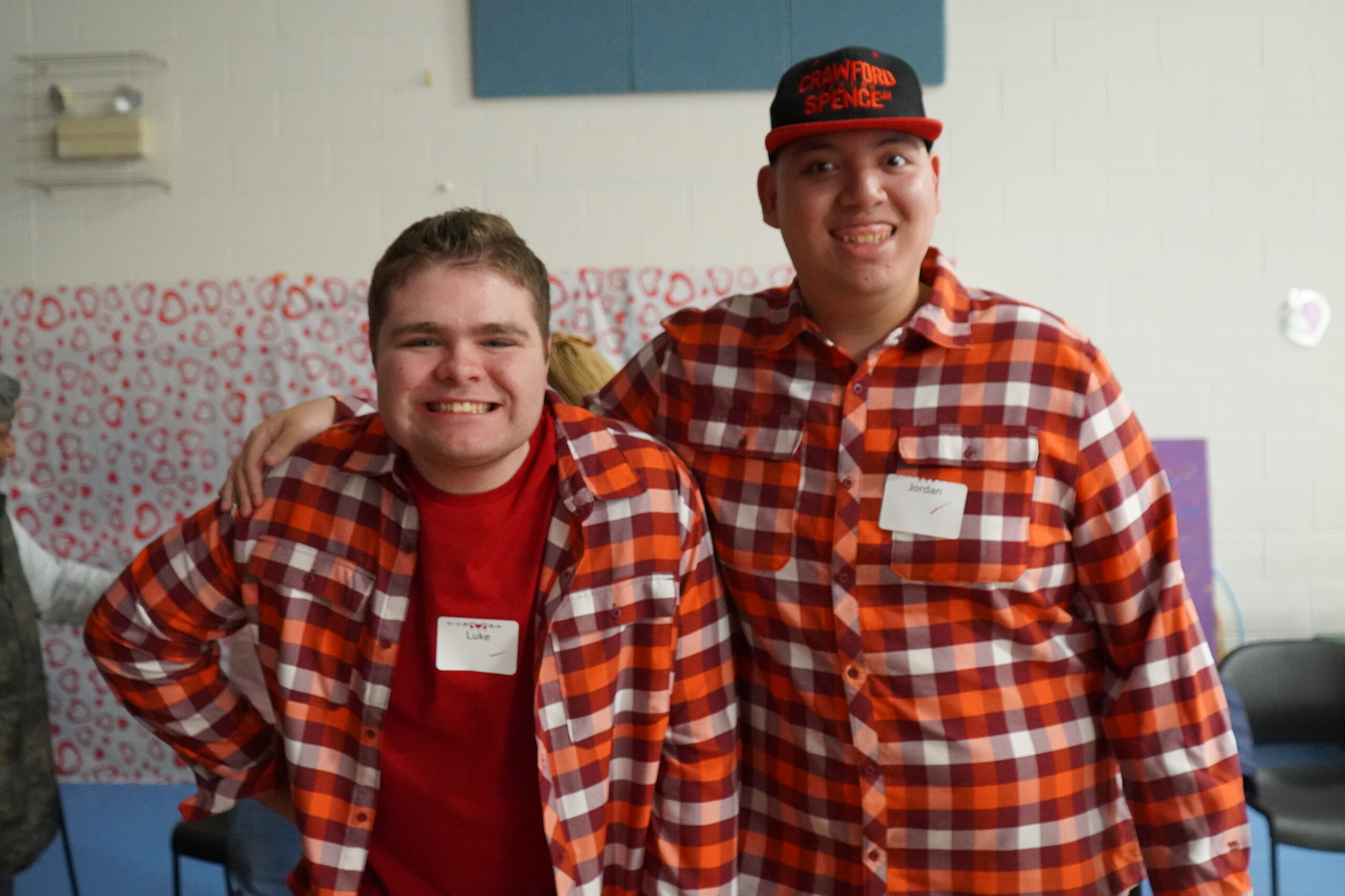 A picture of two CEL members smiling while wearing matching shirts during Sweetheart Dance.