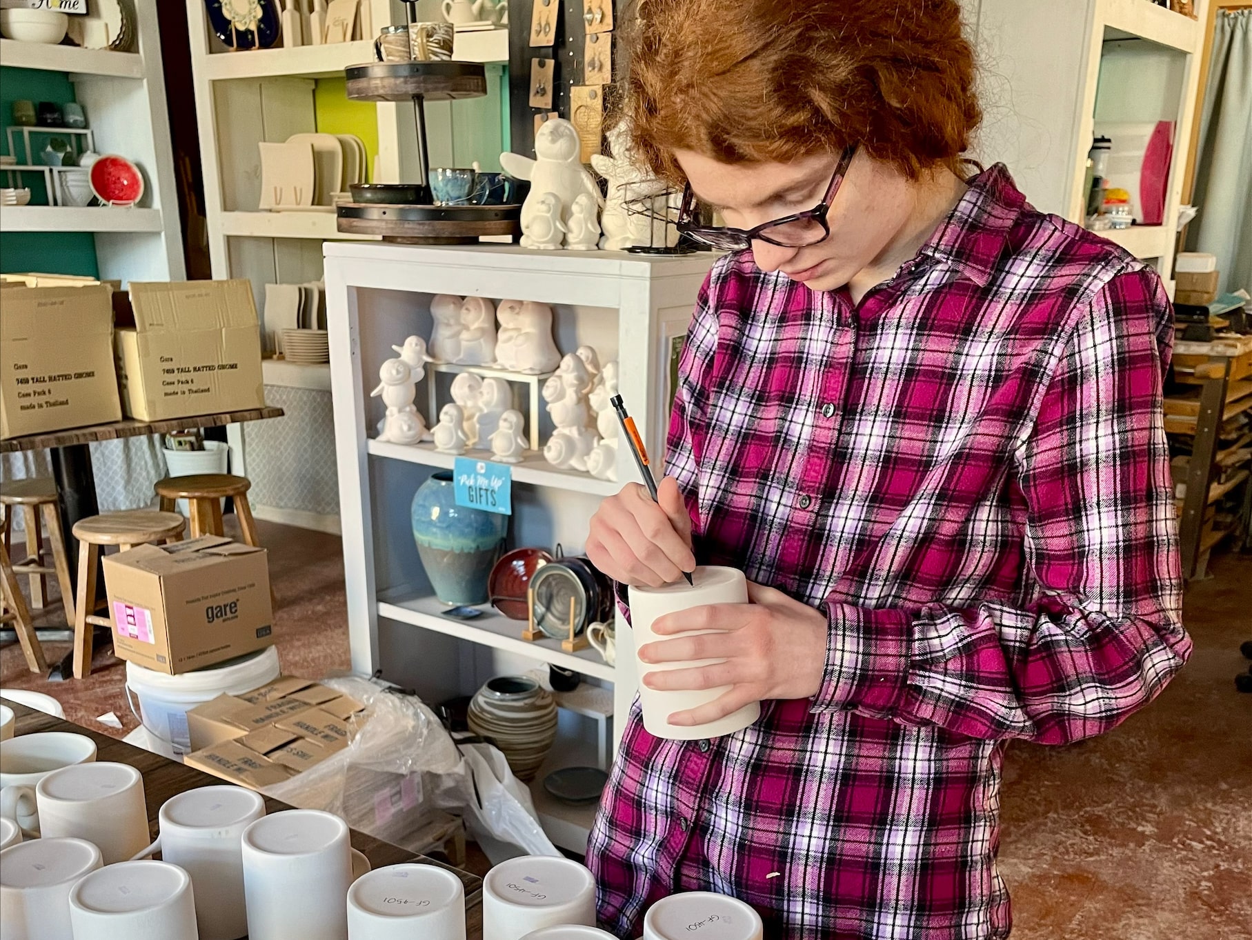A picture of CEL member Hanna at her job at Thrown Elements.