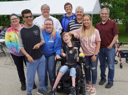 Nine CEL members and their family members pose for a group photo outside