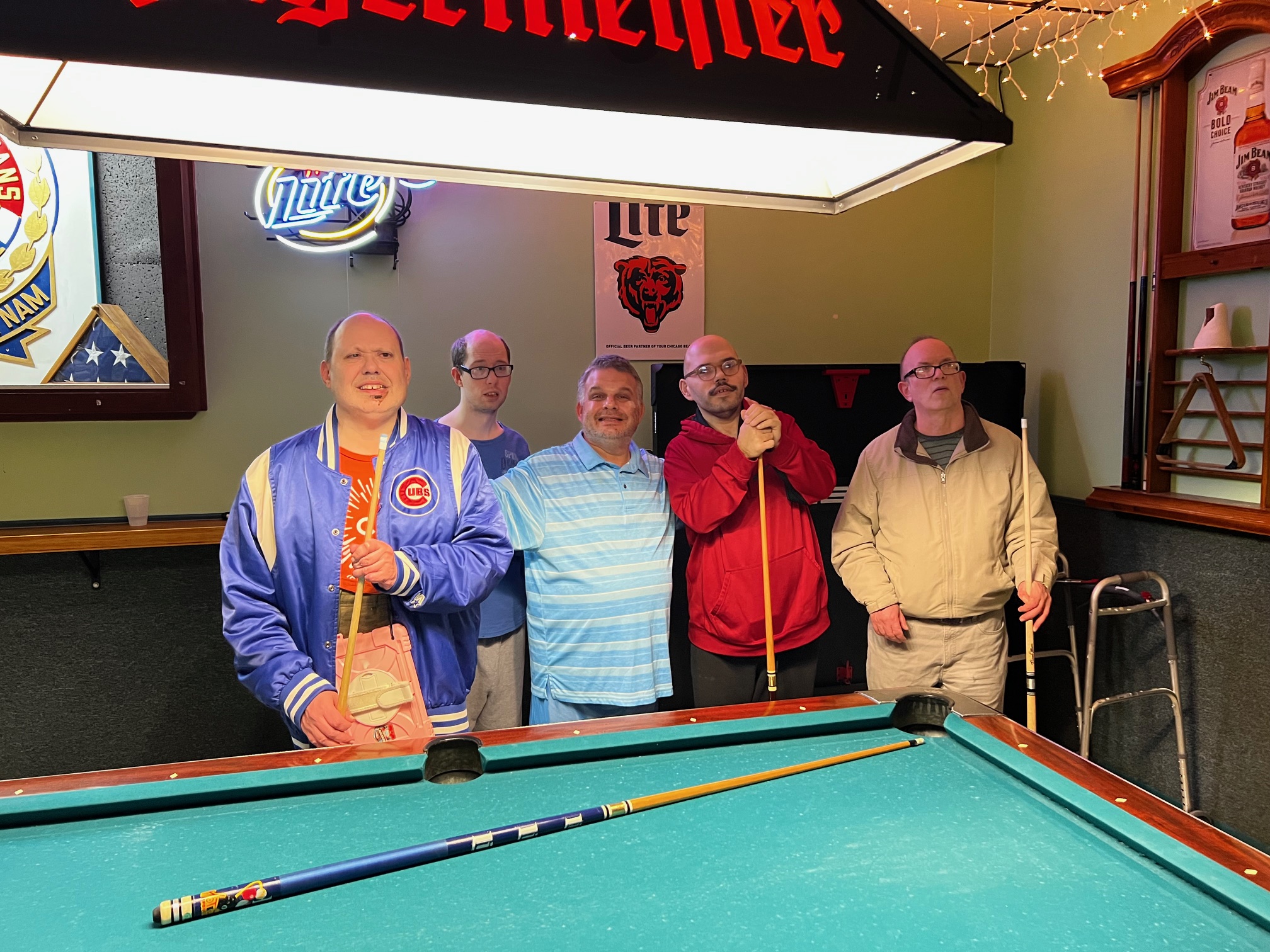 A group of CEL Thursday's Guy's Night members playing pool at the local bar.