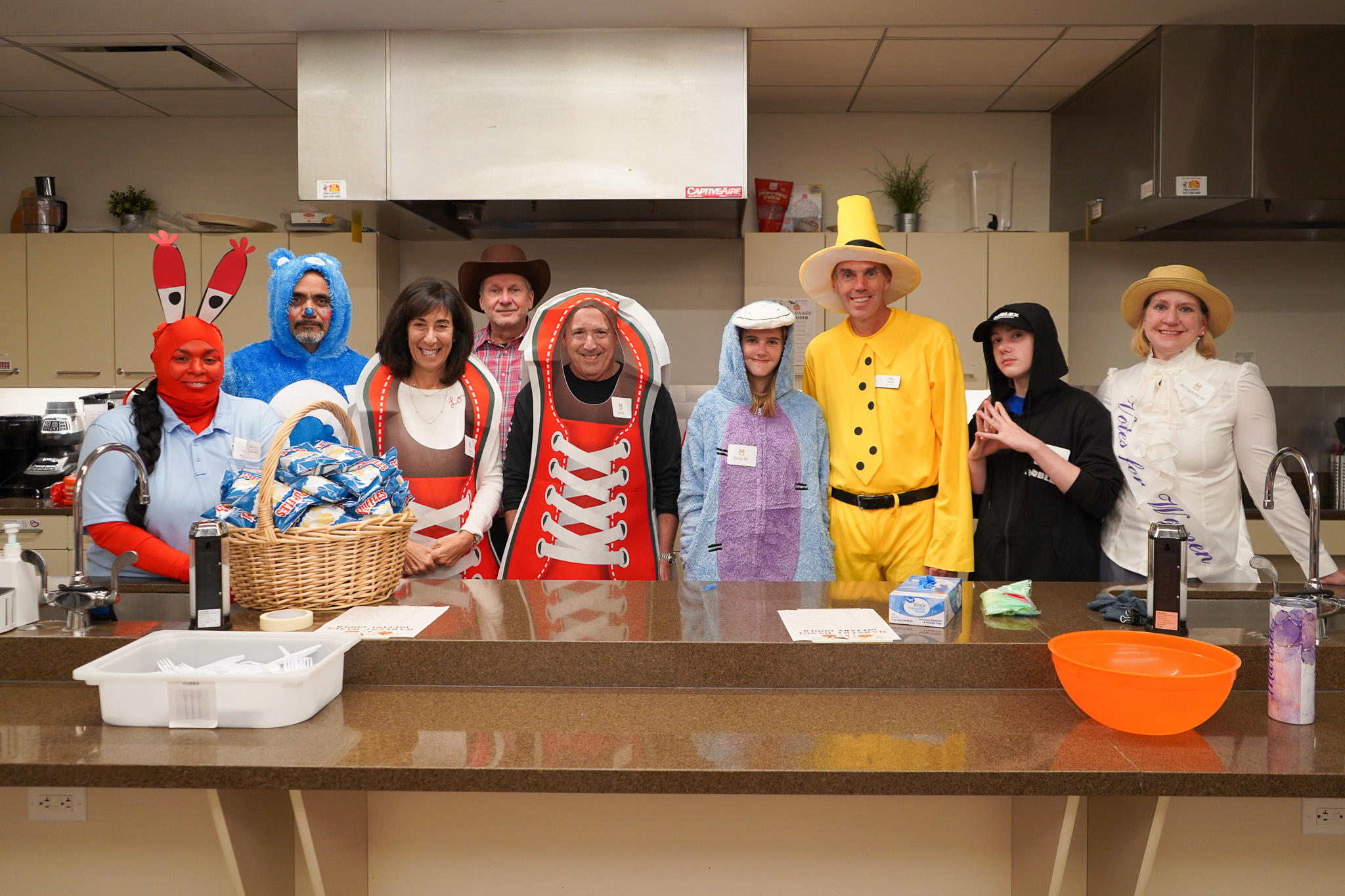 Nine staff members dressed in halloween costumes