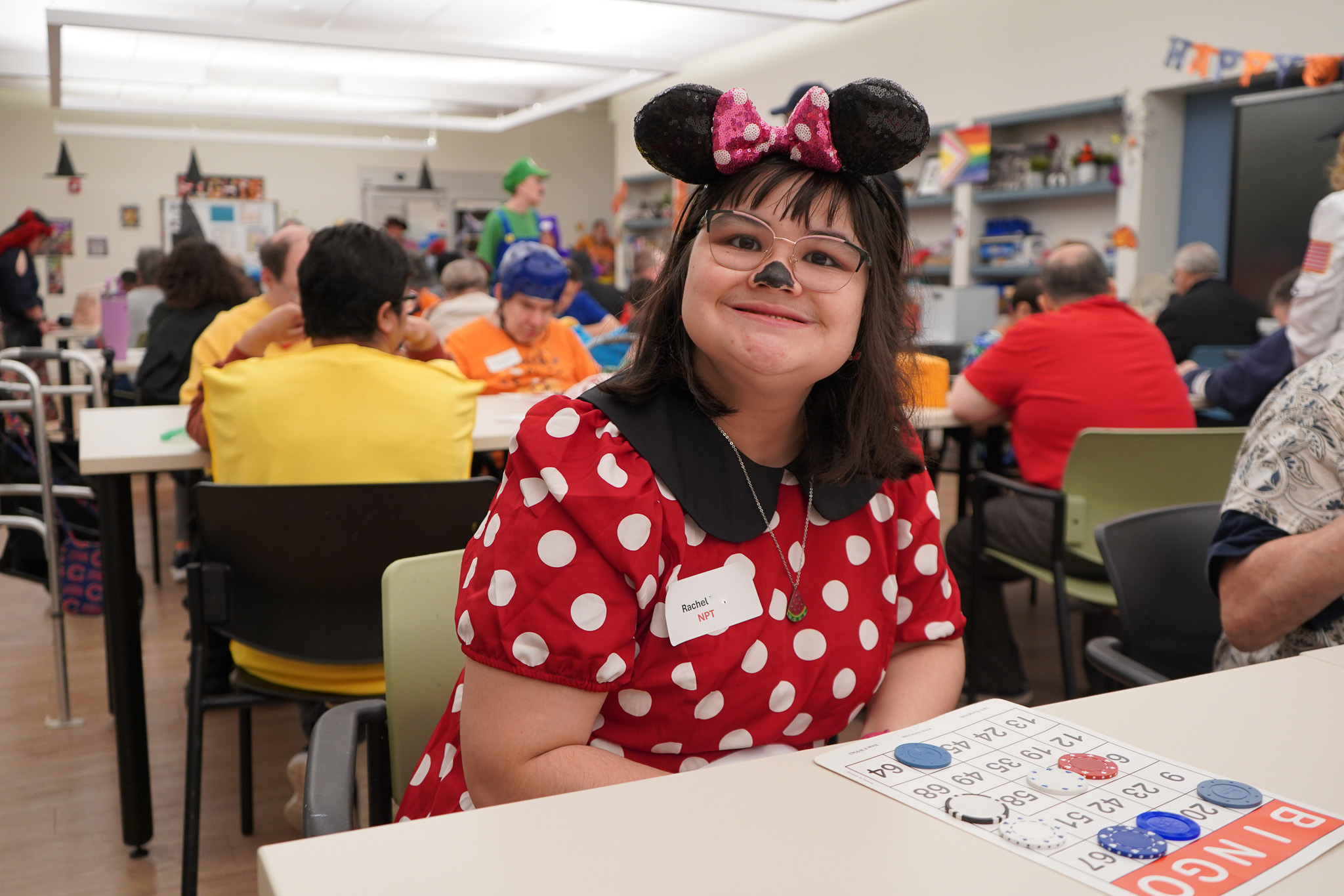 a member dressed as Minnie Mouse plays bingo