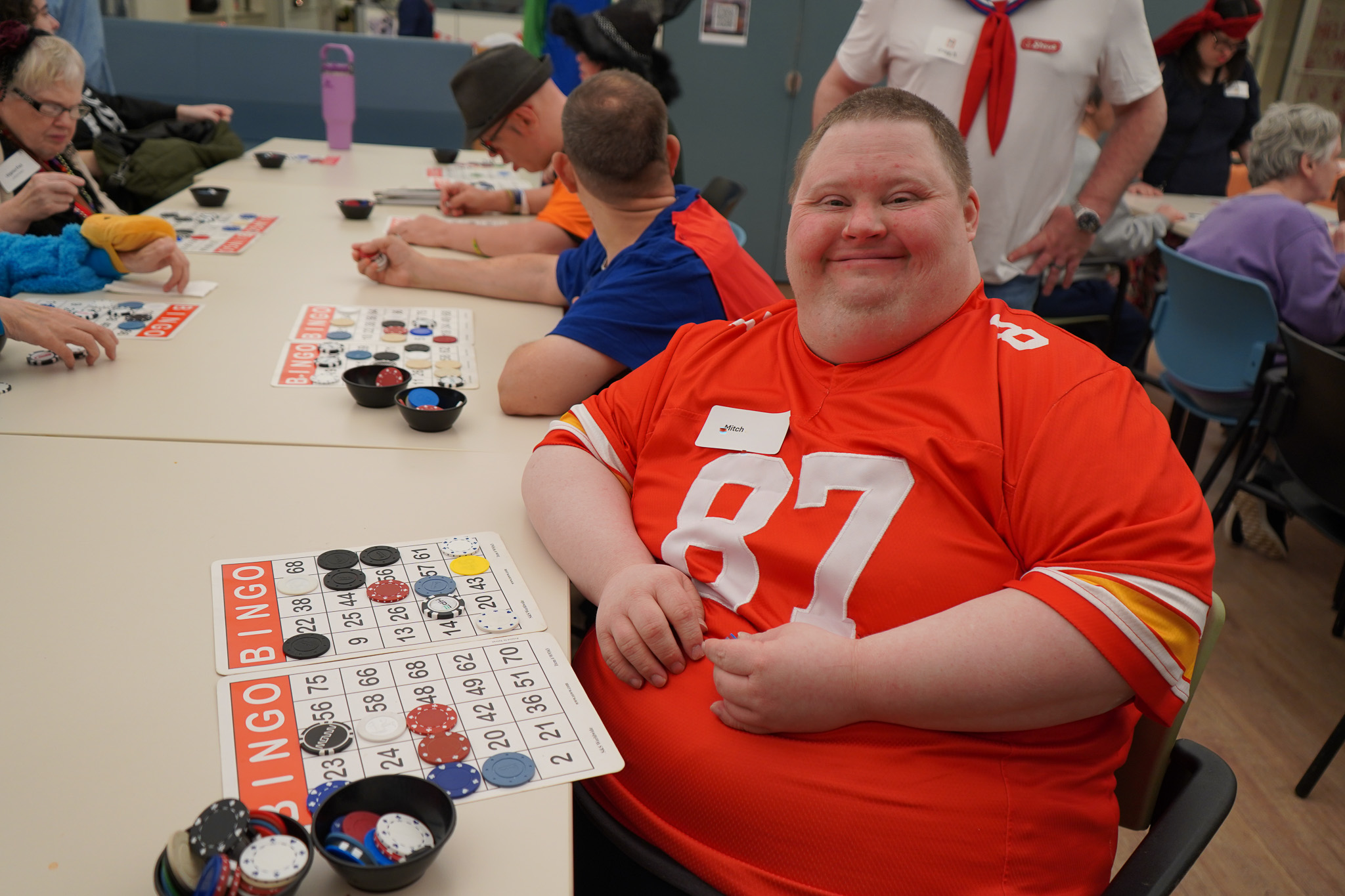 A member dressed as a football player plays bingo