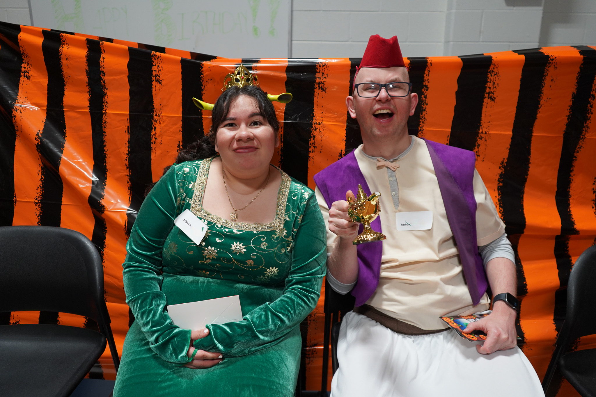 Members pose in Fiona and Aladdin halloween costumes at the Harvest Dance