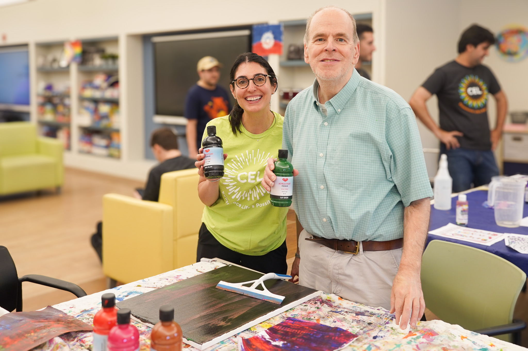 CEL member and staff hold paint at Tuesday night Art