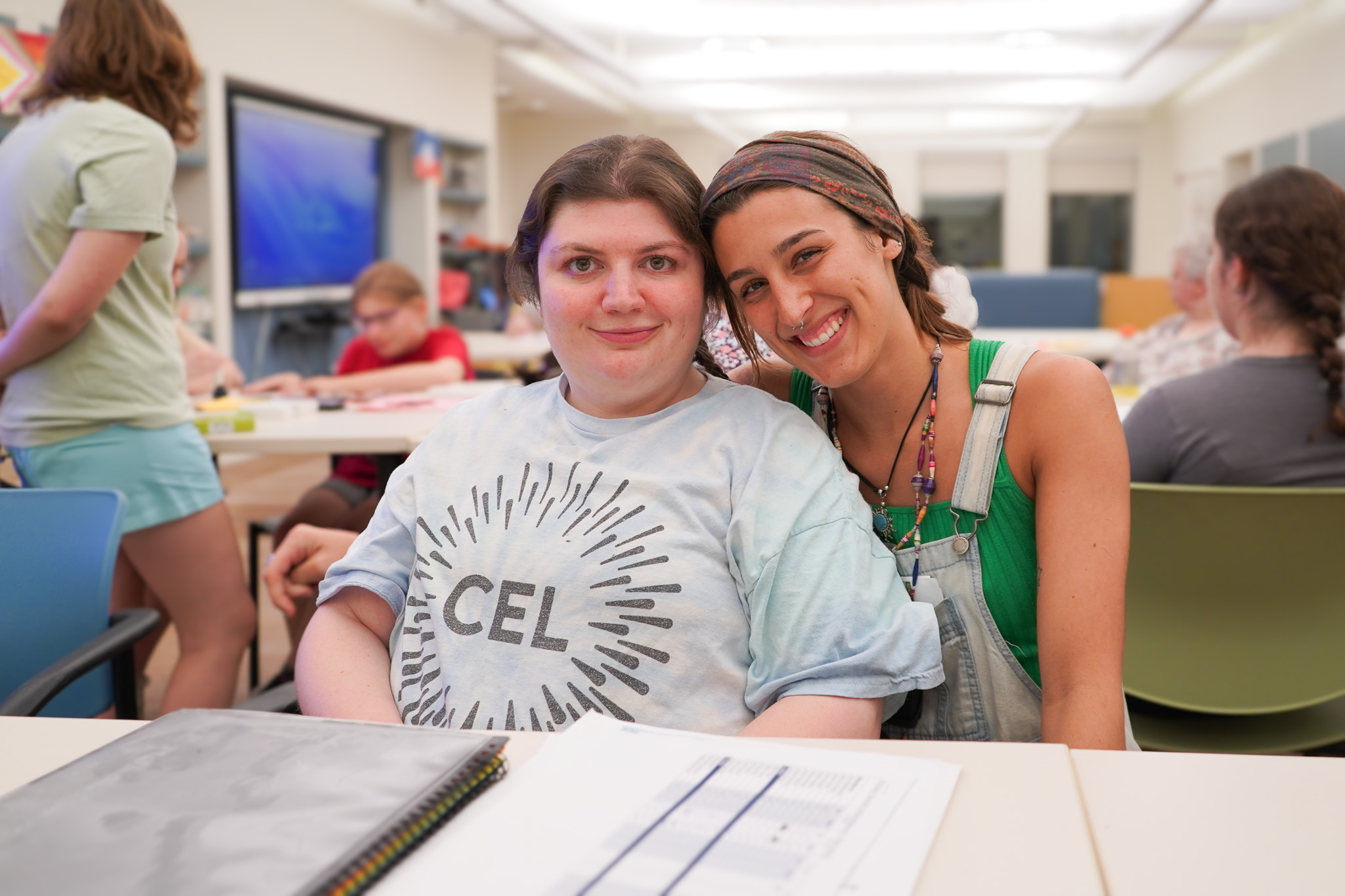 Staff member and a member pose for a photo