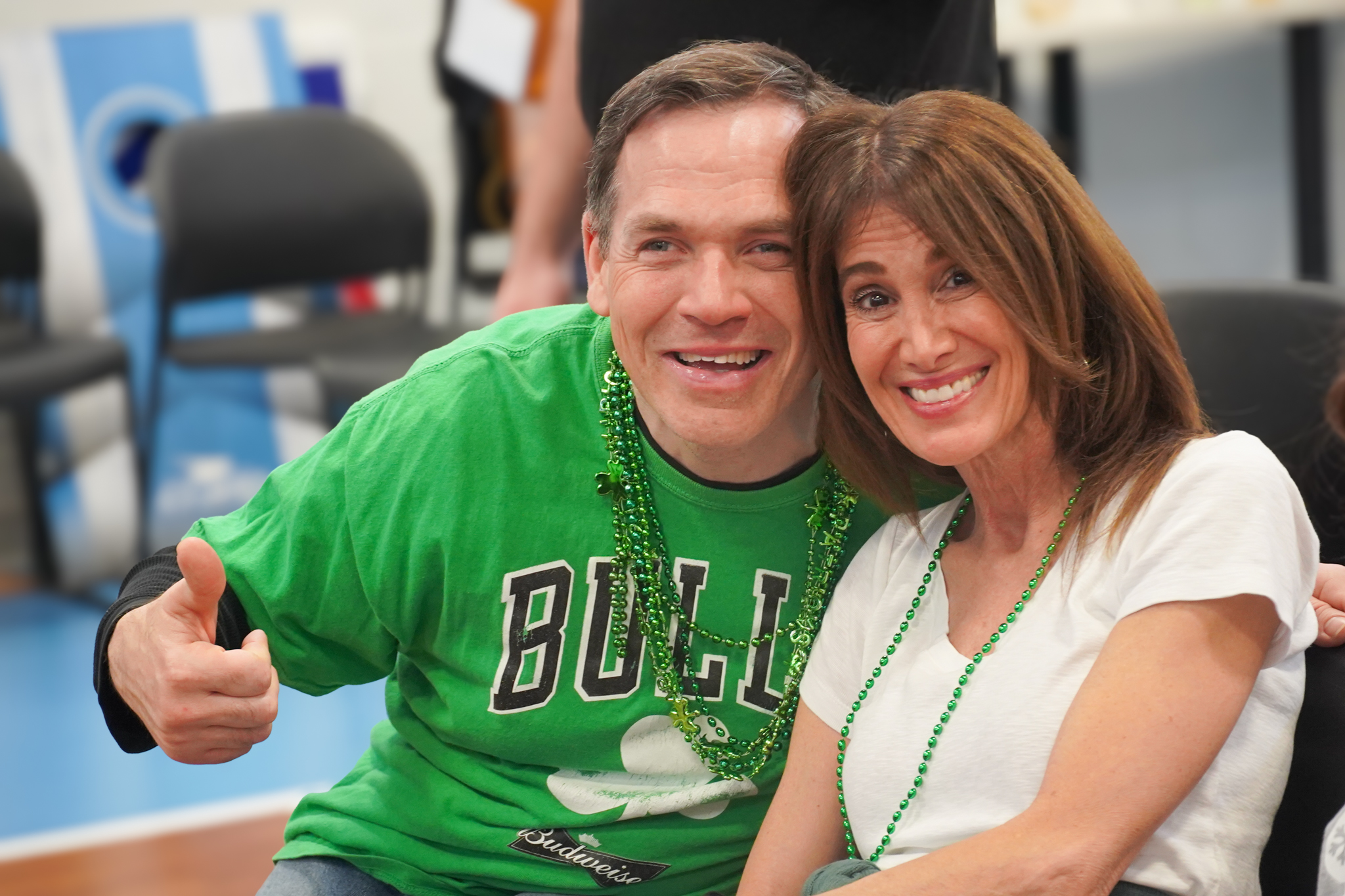 A volunteer and member smile together