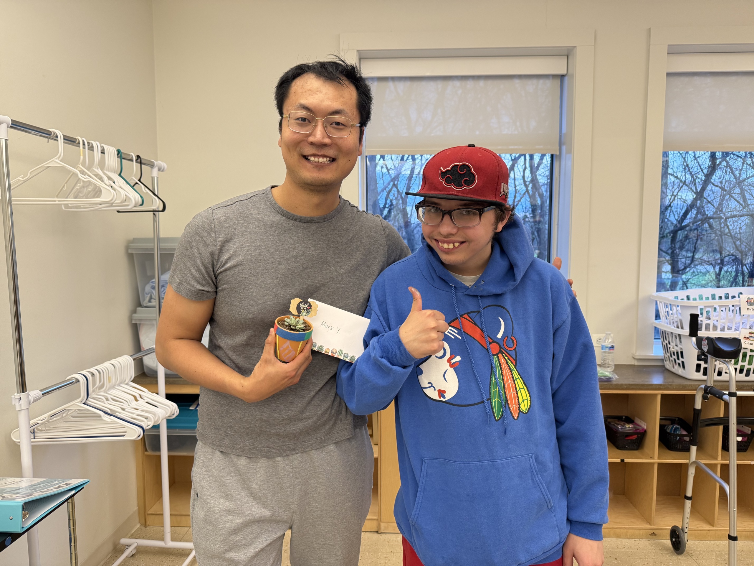 A volunteer and member pose for a photo