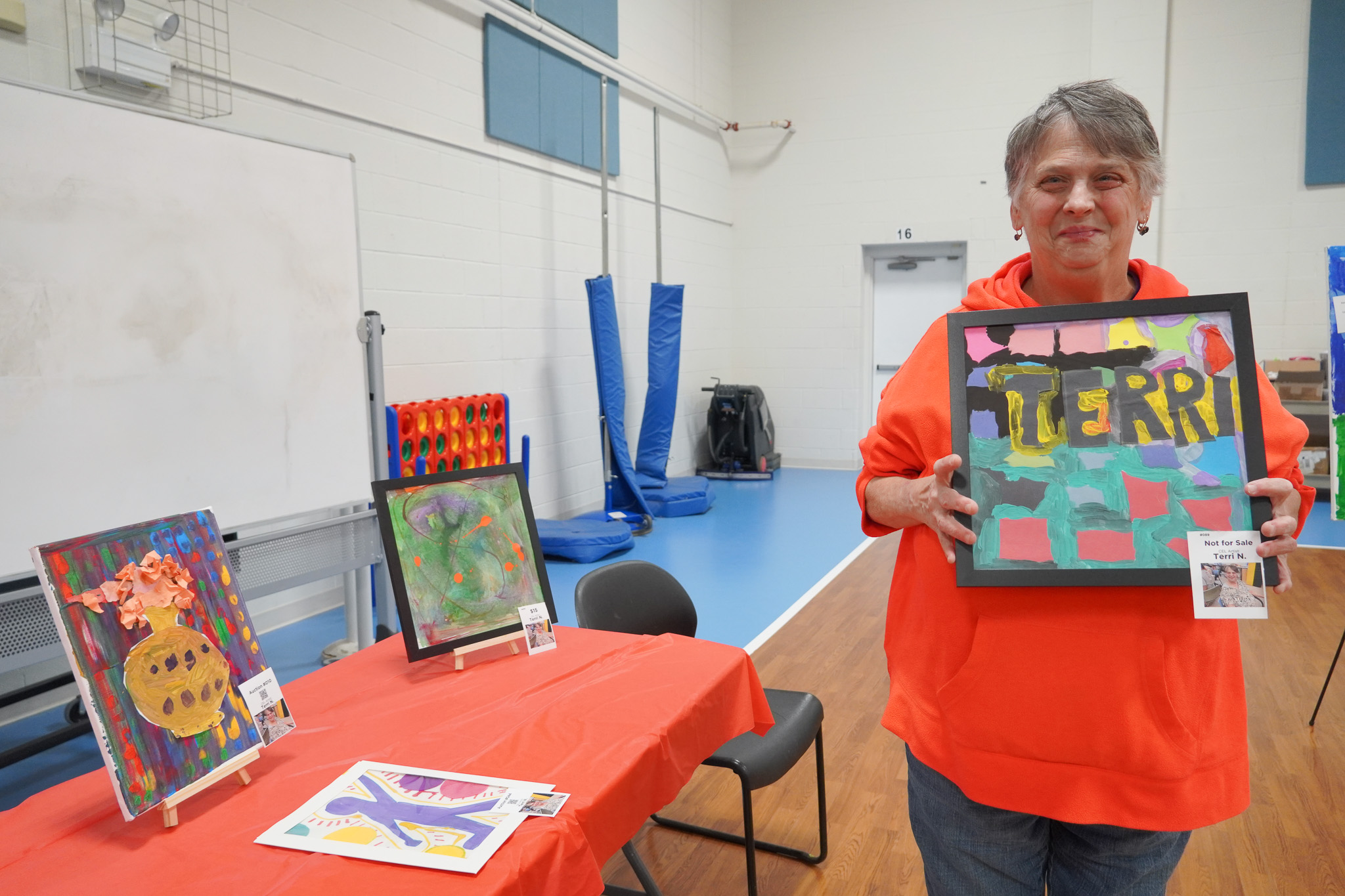 Artist with art at Artful Evening