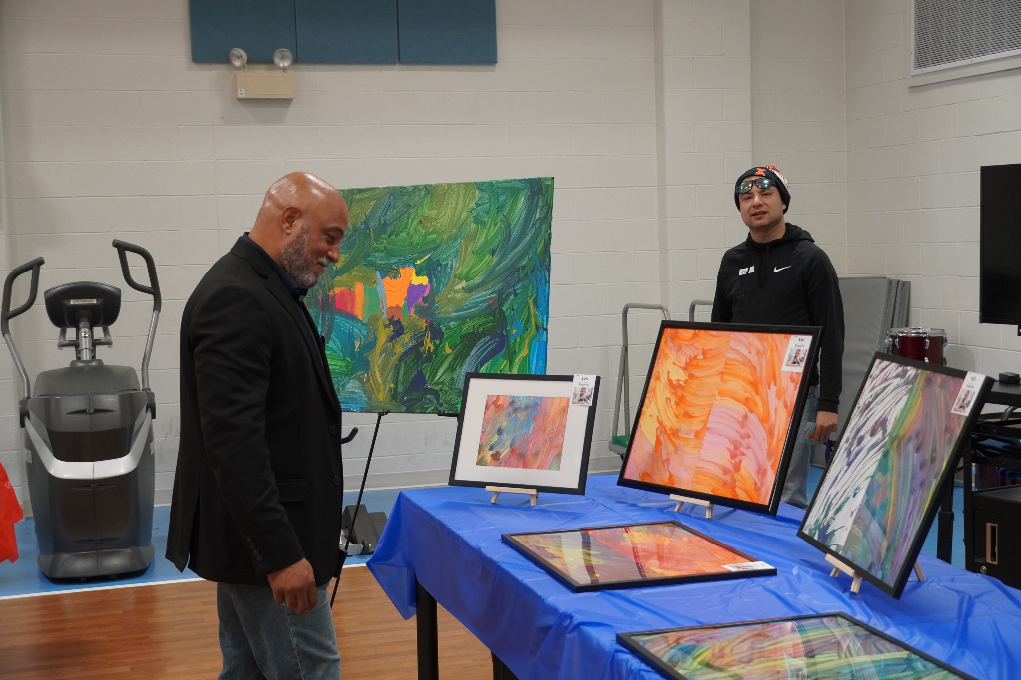 CEO Herb Washington loks at art at Artful Evening