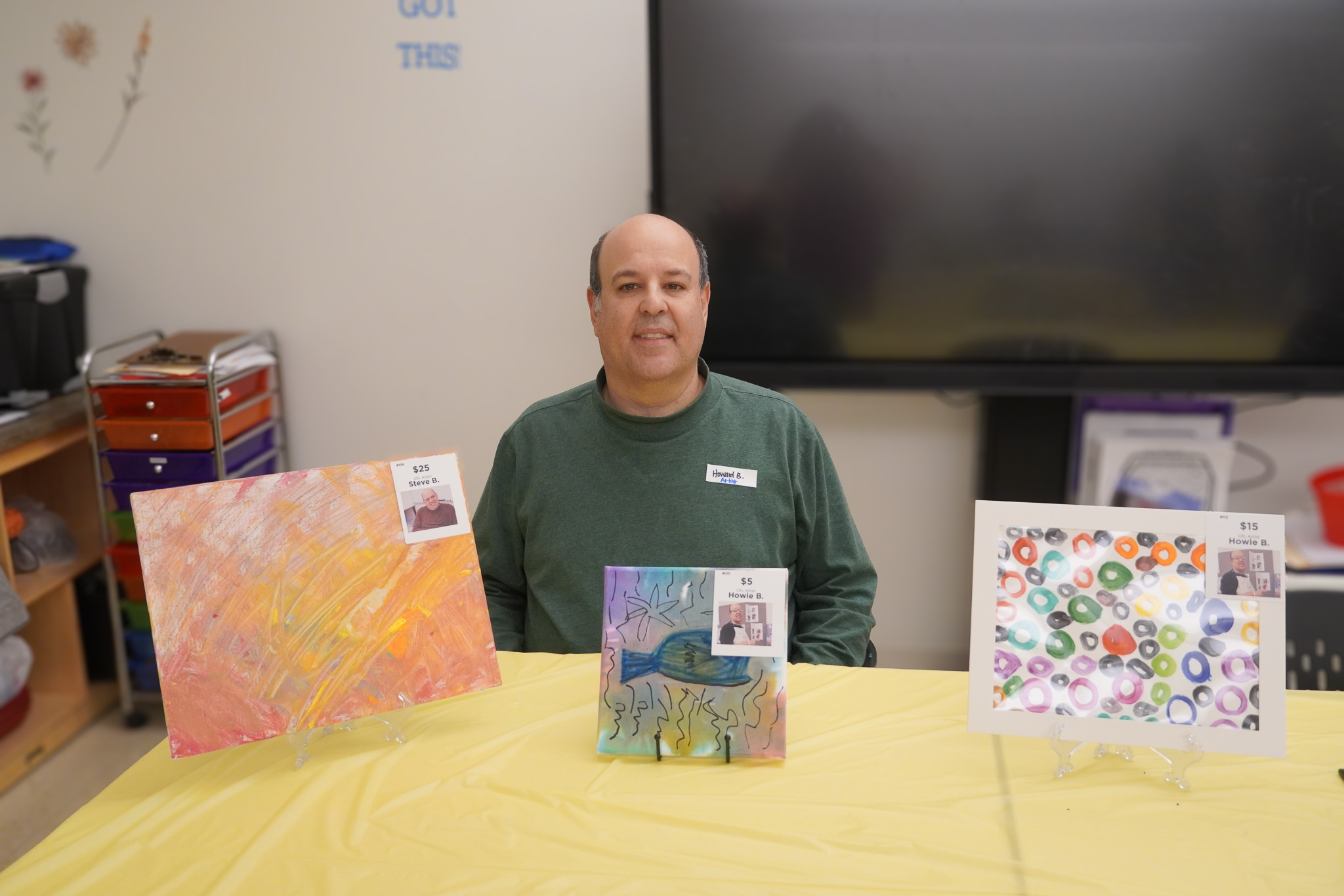 Artist with art at Artful Evening