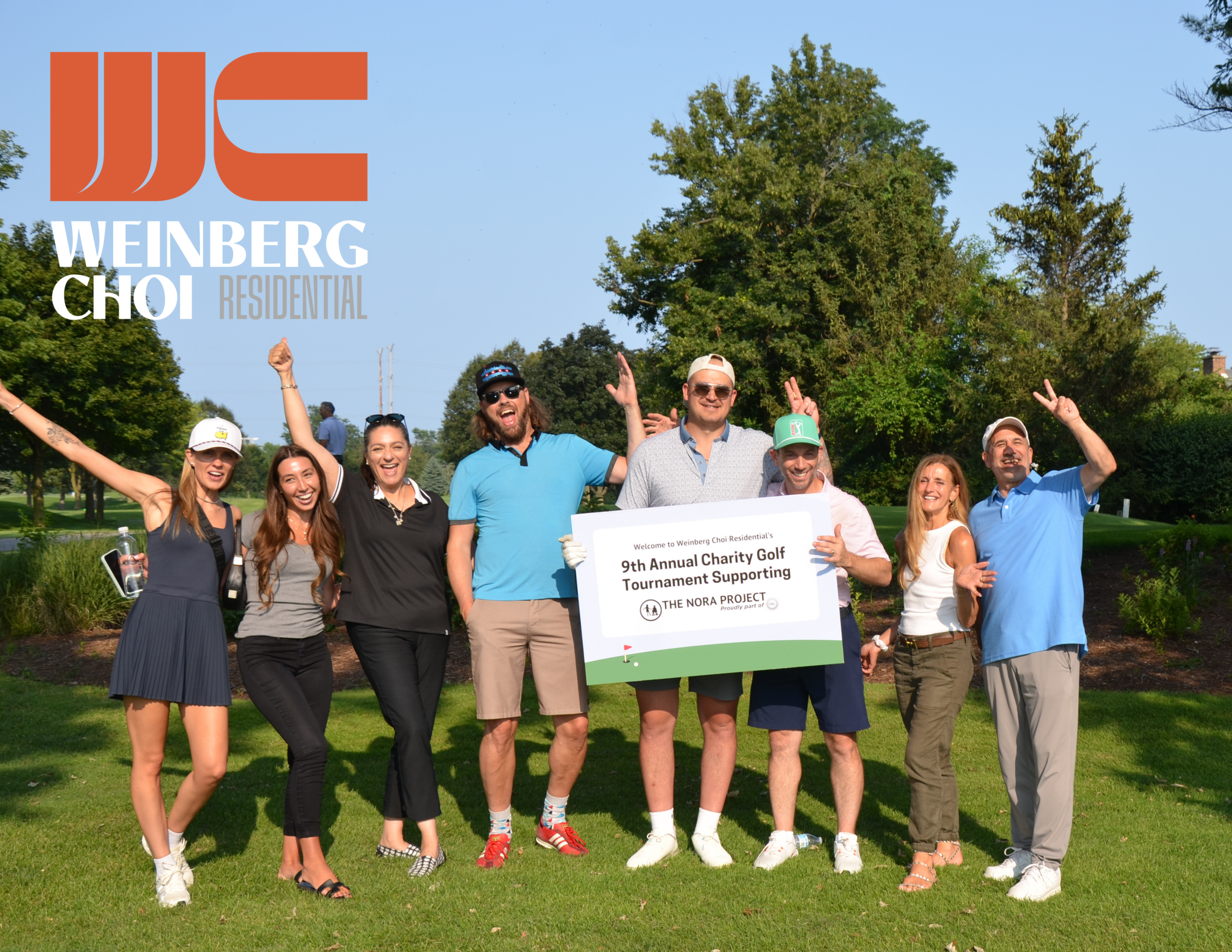 Weinberg Choi golf outing attendees posing with sign