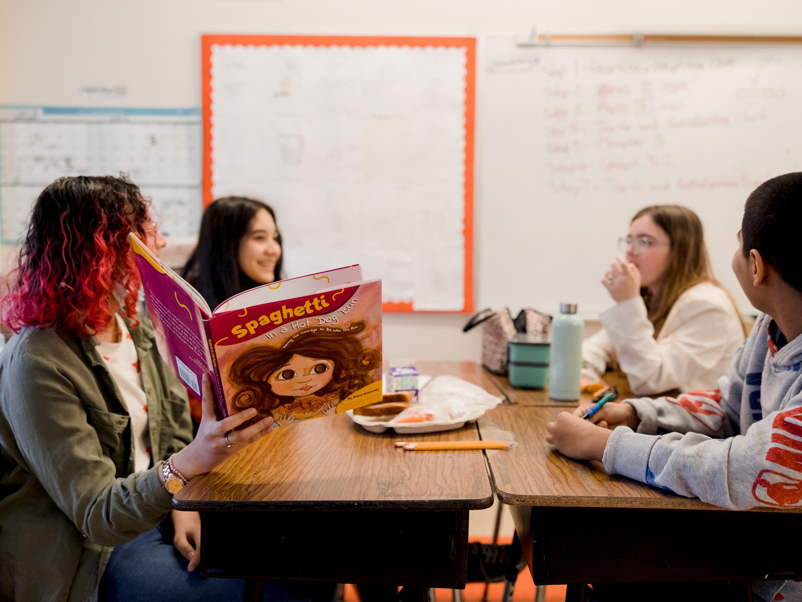 students reading a book together